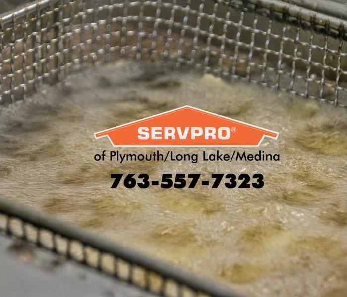 Deep fryer with hot oil and an orange SERVPRO logo.